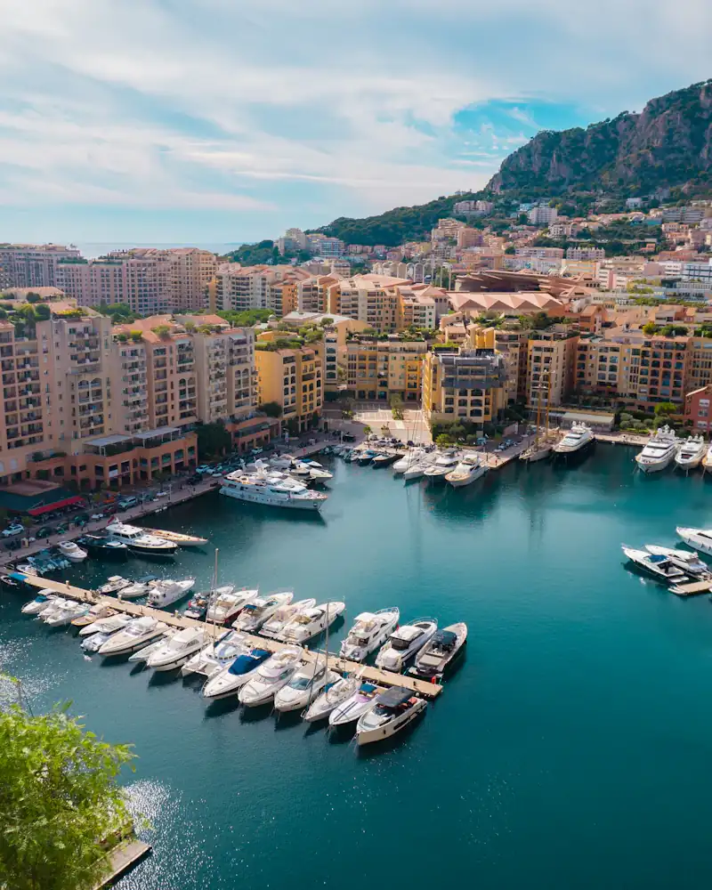 Mediterranean harbour with boats and city buildings in Monaco